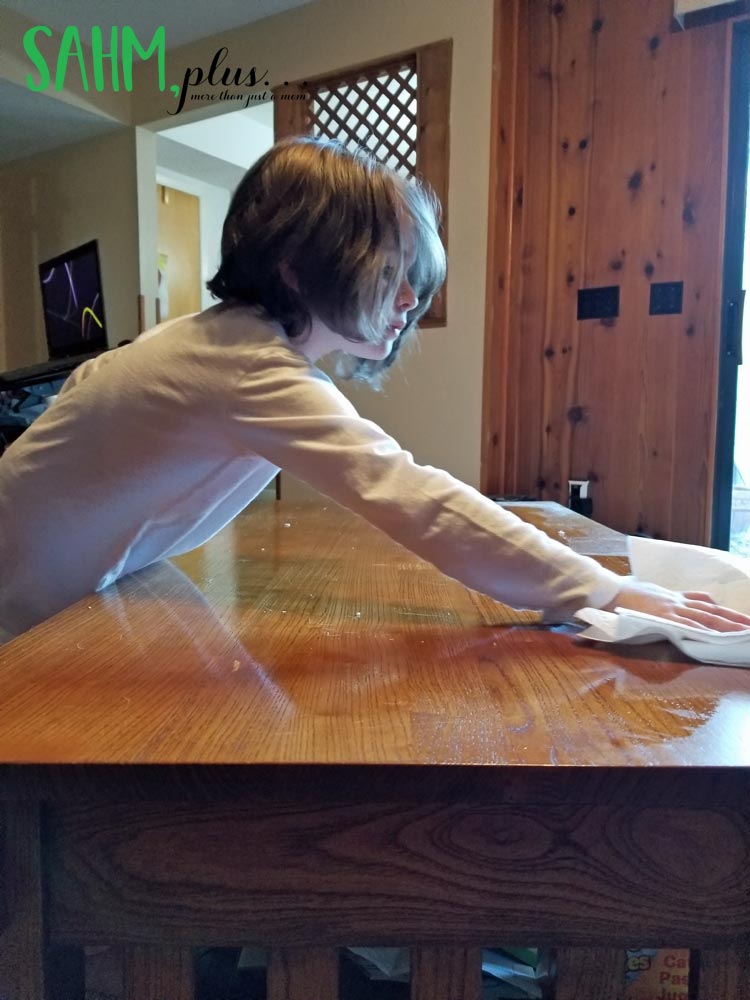 my 6 year old cleaning and dusting the coffee table as a consequence chore
